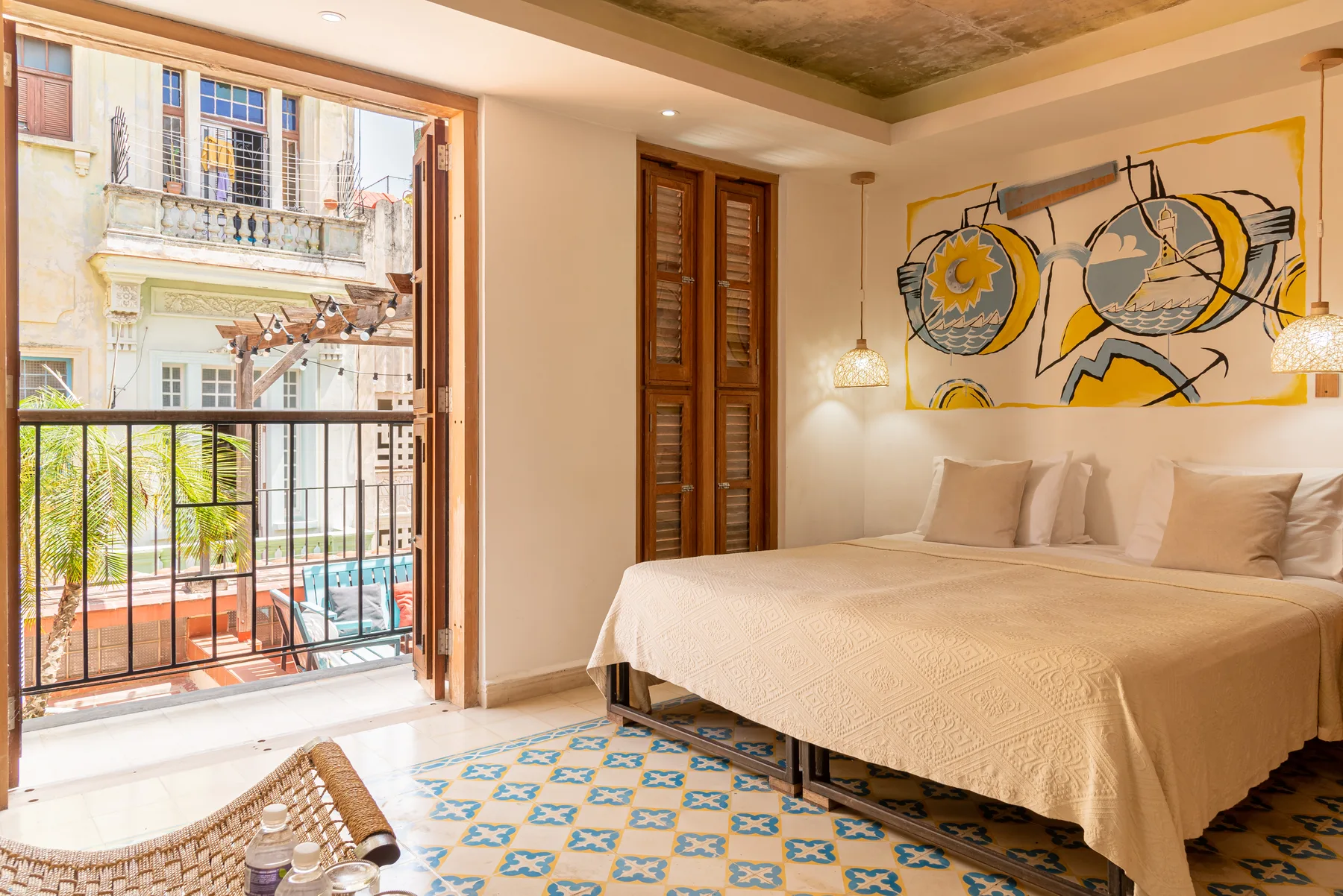 Superior Plus room with original patterned tile, woven lounge chairs, and recycled-wood bathroom doors